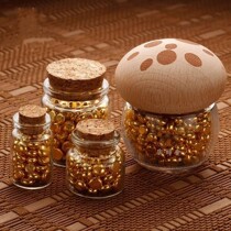 A bottle of golden beans a glass bottle of golden beans a small bottle of small golden beans a wishing bottle an exquisite empty bottle and a small and exquisite