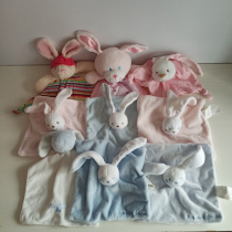 The little rabbit soothes the towel and the baby soothes the toy nibbling away with a little bit of hair.