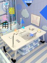 The desk sitting on the bed folding the small table ins the carpet floating on the windowsill Kang for the bed.